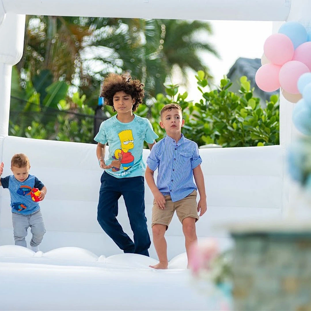 white bounce house rental gender reveal